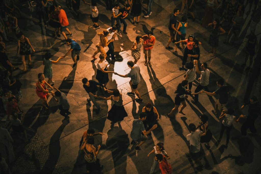 A group of people dancing together, representing queer fitness classes and affirming movement in Austin